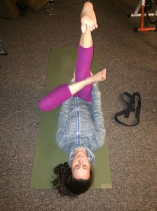 Place both feet on the mat with your knees up and then take your left ankle on to your right knee with your left knee out. Reach your left arm inside the triangle you made with your left leg and your right arm around your right leg. Extend your right leg up and clasp your hands on your thigh. 