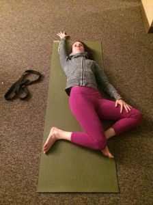 Bring your feet to mat width  and have your knees up. Then allow your knees to fall all the way over to the right and reach your left arm up. 