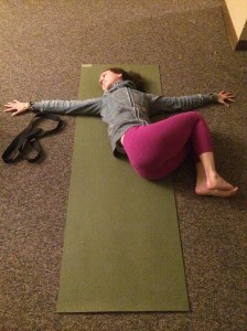 Draw both knees into your chest and bring your arms out to a "T" position. Allow the legs to drop to one side and turn your head the other way. 