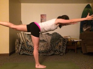 Warrior III: Step one foot forward and lift the back leg up by hinging forward at your hips. Keep your spine straight, push out through your back heel and reach your arms forward. Try to make yourself feel as long as you can from fingertip to heel.